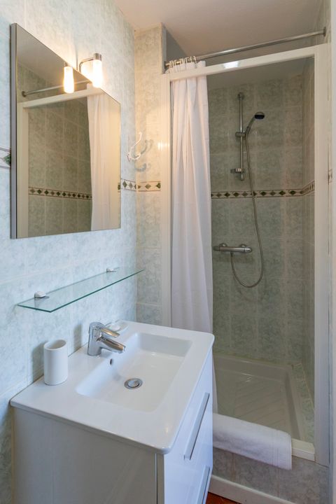 Salle de bain disposant d'une douche et d'un lavabo